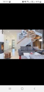 a living room with a blue couch and a table at Cozy Apartment In Pietarsaari in Pietarsaari