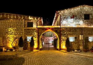 an entrance to a stone building with lights at THE RED HORSE HOTEL in Urgup