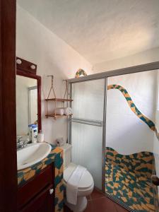 a bathroom with a shower and a toilet and a sink at Mia Nueva Gorgona in Nueva Gorgona