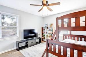 a bedroom with a bed and a ceiling fan at North Raleigh Private Retreat in Raleigh