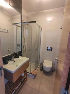 un bagno con lavandino, doccia e WC di Luxury apartment in Vitismar condo view sea & pool a Galé