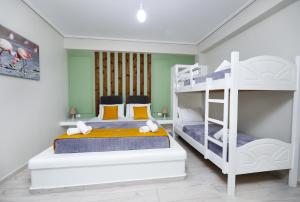 a bedroom with two bunk beds and two bunk beds at Guest House Narta in Vlorë