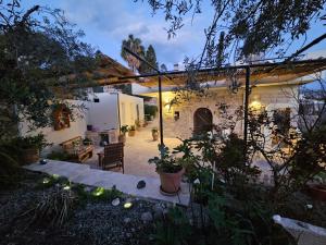 a courtyard of a house with a patio at Papas Apartments in Moírai