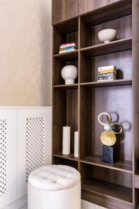 a white ottoman in a room with a book shelf at N16 Deluxe Apartment in Budapest