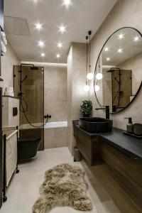 a bathroom with a black sink and a mirror at N16 Deluxe Apartment in Budapest