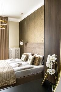 a bedroom with a bed and a mirror at N16 Deluxe Apartment in Budapest