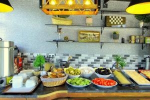 a buffet with bowls of food on a counter at Güler Palas İstanbul Hotel in Istanbul