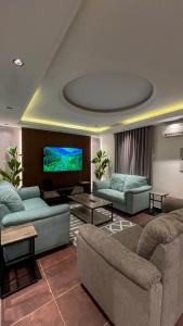 a living room with couches and a flat screen tv at أبها مارينا فيلا in Abha