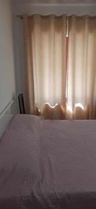 a bedroom with a large bed and a window at Flat rent berat in Berat