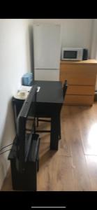 a black table and chair in a room at London x DM Weekly x Monthly Discounts x W13 in Greenford
