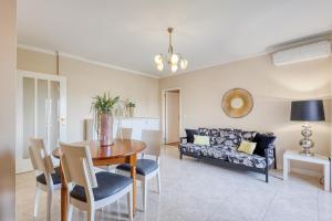 a living room with a table and a couch at Candal Douro in Vila Nova de Gaia