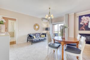a dining room and living room with a table and a couch at Candal Douro in Vila Nova de Gaia +13 photos