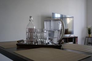 a blender and glasses sitting on a table at Falkirk City Centre Stylish Two-Bedrooms Apartment in Falkirk +28 photos