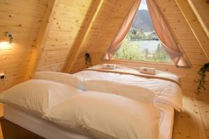 two beds in a room with a window at Cottages Relax in Jajce