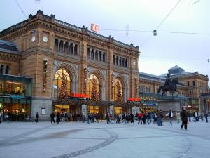 a large building with people walking in front of it at Hotel Central Hannover in Hannover