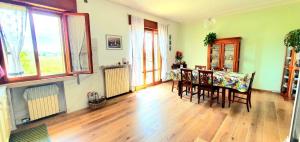 a living room with a dining room table and chairs at Villa Sartori in Legnago