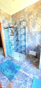 La salle de bains est pourvue d'une douche avec une porte en verre. dans l'établissement Villa Sartori, à Legnago
