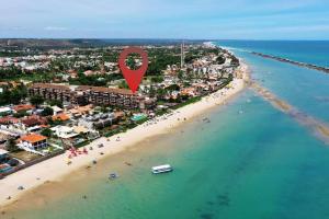 an aerial view of a beach with a red marker at Beira-Mar 4 Suítes/ piscina / churrasqueira /campo in Barra de São Miguel