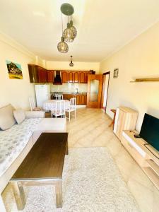 a living room with a couch and a table at N&E Apartment 1 in Durres, Beach. in Durrës