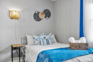 a bedroom with a bed with blue and white pillows at Pet friendly Studio with Private Yard in Orlando