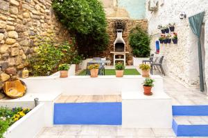 un patio con plantas y escaleras azules y blancas en Casa rural "Cuenta la Leyenda..." en Bulbuente