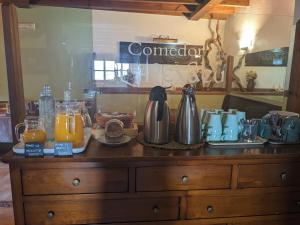 a wooden dresser with various items on top of it at Hotel Rural El Rexacu in Bobia de Arriba