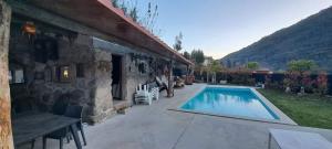 a house with a swimming pool next to a building at Casa do Garrano - Gerês in Vilar da Veiga