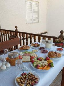 a table with many plates of food on it at DD Villa in Berat