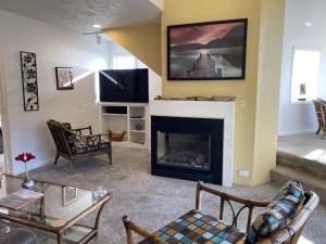 a living room with a fireplace and a tv at Starfish Point in Newport
