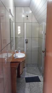 La salle de bains est pourvue d'un lavabo et d'une douche. dans l'établissement Pousada Wunderland, à Palmeira