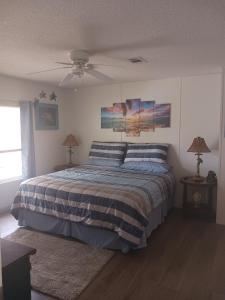 a bedroom with a bed and a ceiling fan at Turtles Nest of Port Orange in Port Orange