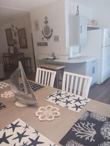 a kitchen with a table with two chairs and a kitchen with a refrigerator at Turtles Nest of Port Orange in Port Orange