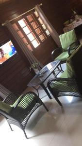 a room with a table and chairs and a television at Resort Nabruni in Belas