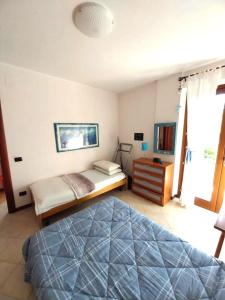 een slaapkamer met een bed en een dressoir bij Casa al mare con giardino in Alghero