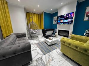 a living room with a couch and a tv at Tranquil Oasis in Gravesend, Kent in Northfleet