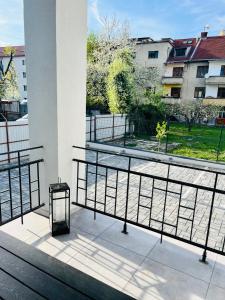 a balcony with a bench and a view of a park at Apartment Riviéra Centrum, private parking and smart check in in Banská Bystrica