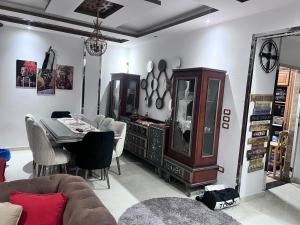 a living room with a table and a dining room at Villa Contenental residense El sheikh Zayed Beverly Hills in Sheikh Zayed