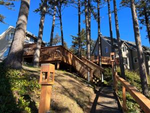 a house with a wooden deck in the woods at Starfish Point in Newport