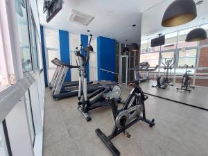 a gym with several treadmills and elliptical machines at Book Santos - Estanconfor 708 - 2 quartos in Santos