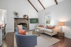 a living room with two chairs and a fireplace at Sawyer's Landing- Mins to beach & Dtwn in Charleston