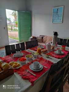 a long table with food on top of it at Hostel do Cerrado in Cavalcante +29 photos