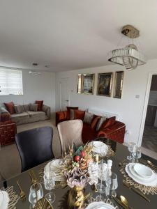 a living room with a table and a couch at Elegant House in Barnstaple