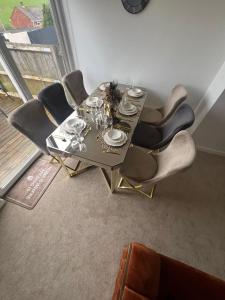 a dining room table with chairs and glasses on it at Elegant House in Barnstaple