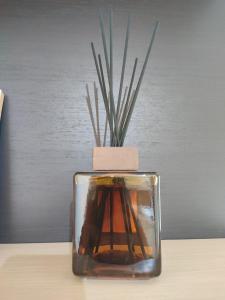 a glass vase with a plant in it on a table at Manila House - private garage - Milan IEO Humanitas in Locate di Triulzi
