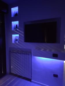 a living room with a tv and blue lights at Manila House - private garage - Milan IEO Humanitas in Locate di Triulzi