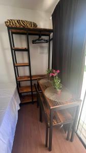 a room with a table and a bunk bed at Chacara Recanto do Pinheiro in Capão do Leão