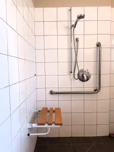 a bathroom with a bench and a shower at Tongariro Junction Accommodation in Turangi