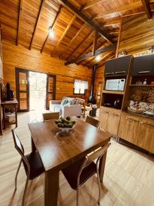 una cucina e una sala da pranzo con tavolo e sedie di casa dos sonhos a Bom Jardim da Serra
