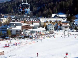 a group of people riding a ski lift in the snow at Apartment Mojstrovka with Sauna and free parking on site in city center in Kranjska Gora