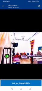 a picture of a living room with colorful pillows at Dar tisir in Essaouira